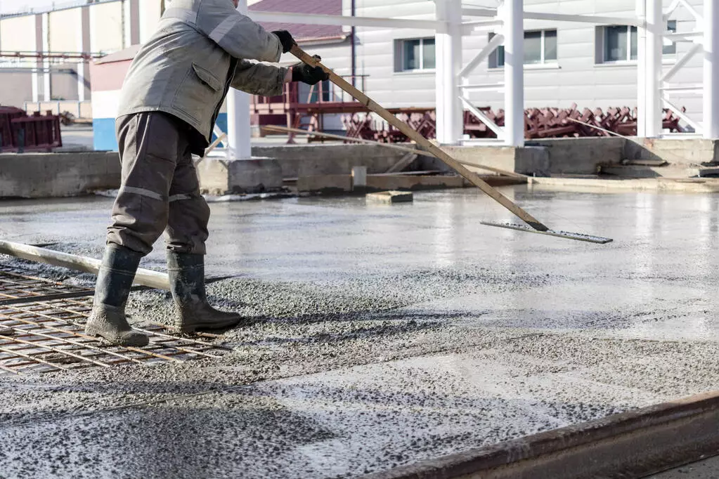 stock-photo-construction-worker-leveling-poured-concrete