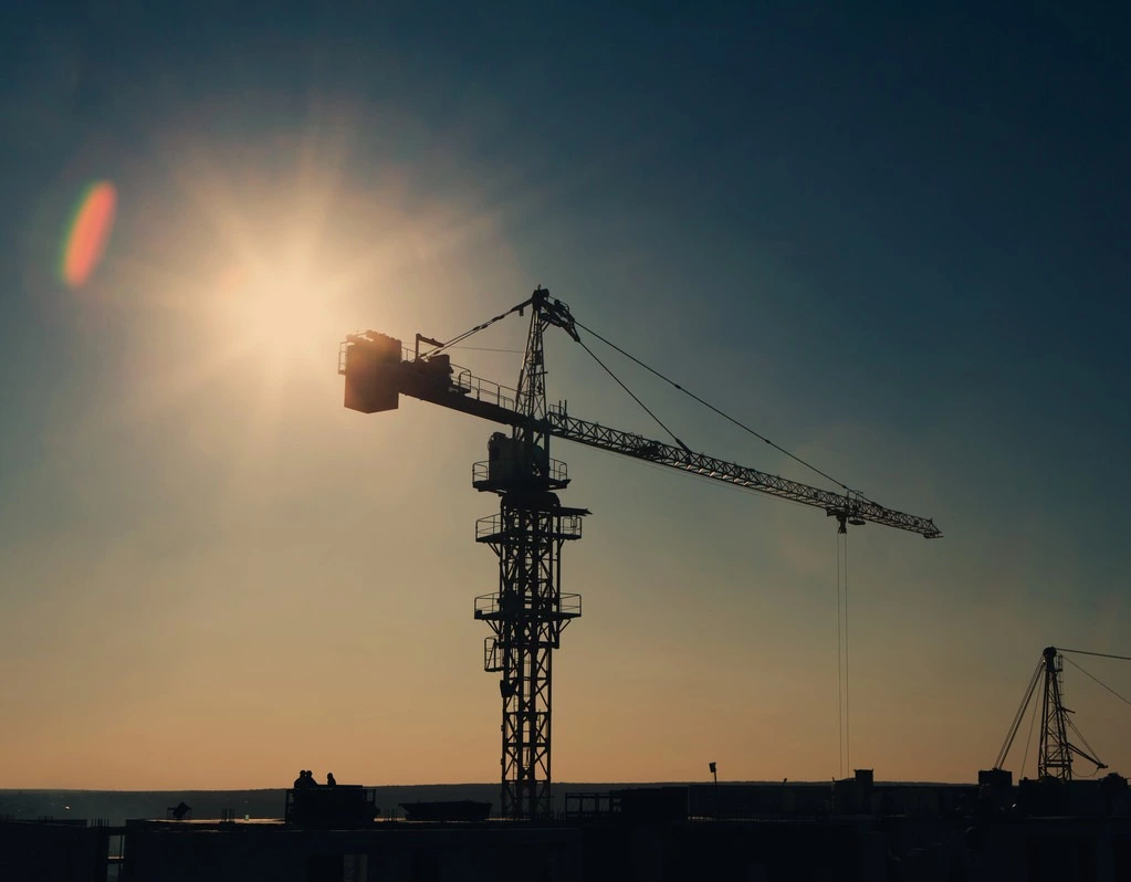 stock-photo-tower-crane-silhouette-at-construction-site